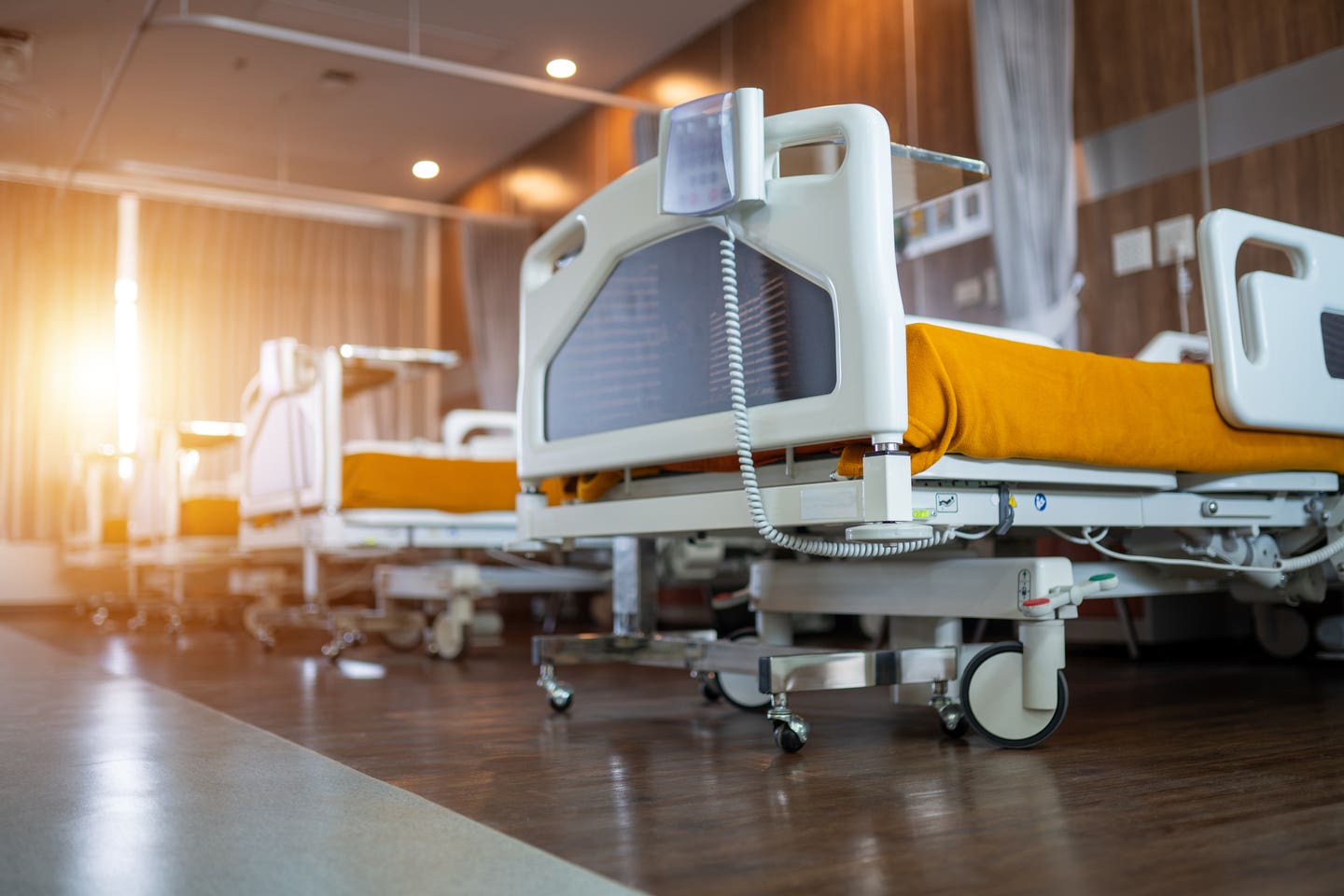 A hospital room with a bed and a phone